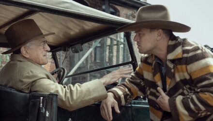 DiCaprio looking at DeNiro in an old car from the 20s