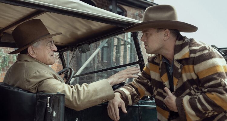 DiCaprio looking at DeNiro in an old car from the 20s