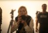 Kirsten Dunst looking from behind her camera in Civil War