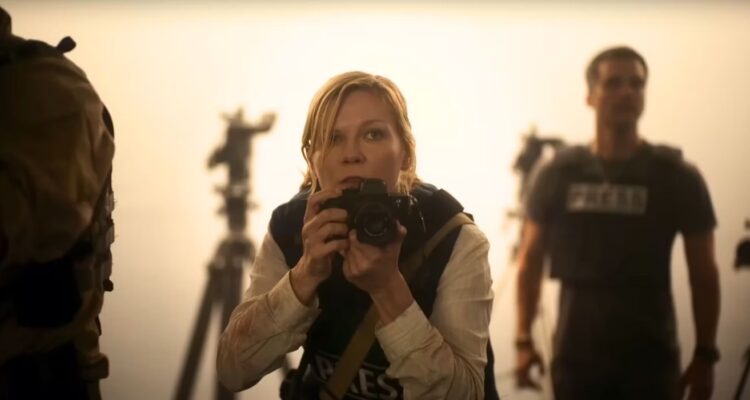Kirsten Dunst looking from behind her camera in Civil War