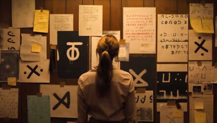 Lee Harker looks at her Zodiac-esque wall mural