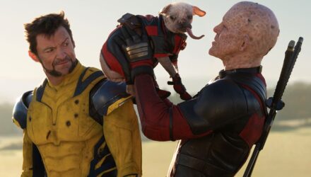 Deadpool holding his Deadpool dog while Wolverine looks on disgusted