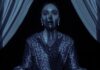 Ellen looks scared with Nosferatu's shadow hand on her face