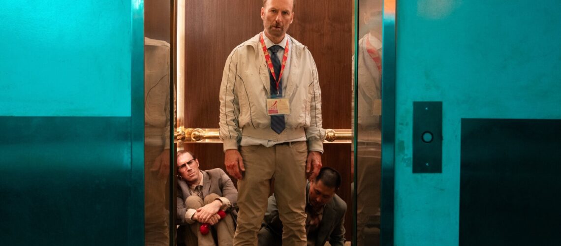 Bob Odinkirk standing bloody in an elevator in Nobody 2 backtothepicture.net still