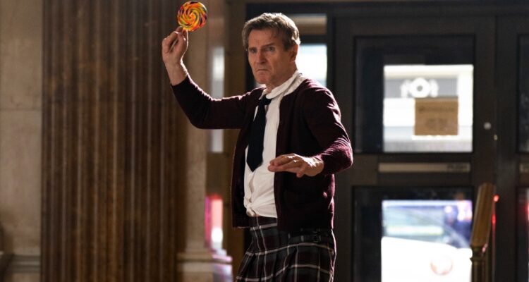 Liam Neeson in school girl outfit about to throw a lollipop from The Naked Gun