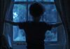 Child looking out the window from Weapons backtothepicture.net movie still