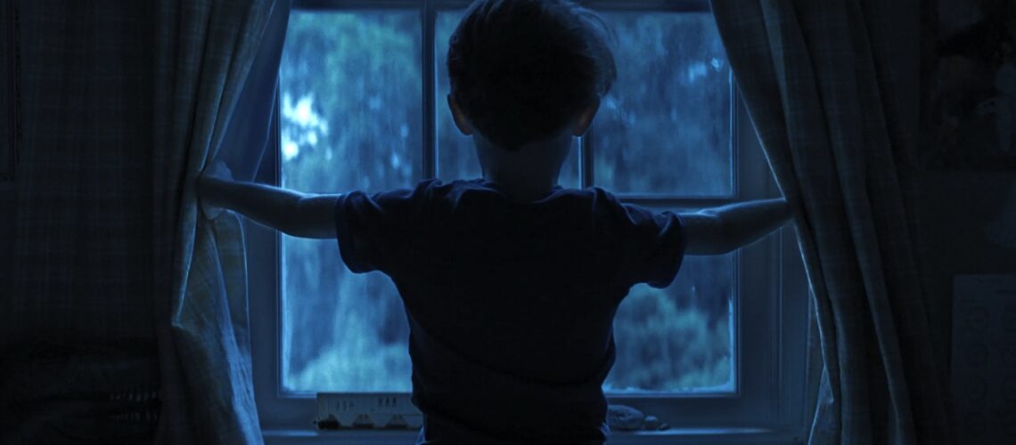 Child looking out the window from Weapons backtothepicture.net movie still
